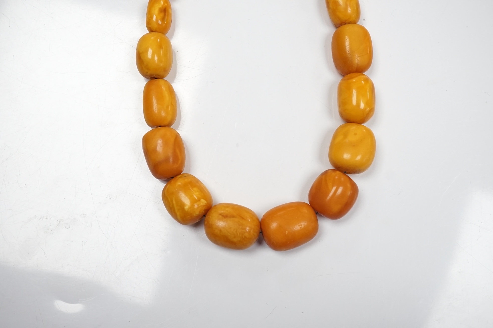 A single strand graduated oval amber bead necklace, 42cm, gross weight 49 grams. Condition - poor to fair